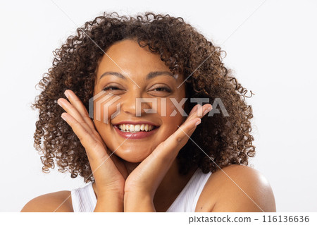 A biracial young female plus size model with curly brown hair on white background A biracial young female plus size model with curly brown hair on white background 116136636