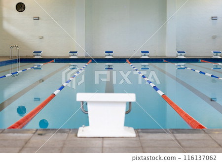 Swimmers are not present in the indoor pool with lanes marked for racing Swimmers are not present in the indoor pool with lanes marked for racing 116137062