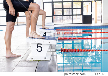 Diverse young swimmers, Caucasian boy on starting block Diverse young swimmers, Caucasian boy on starting block 116137166