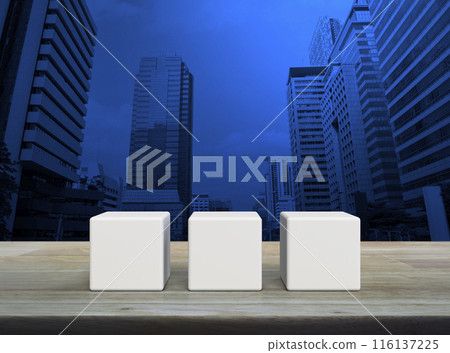 Three white block cubes on wooden table 116137225