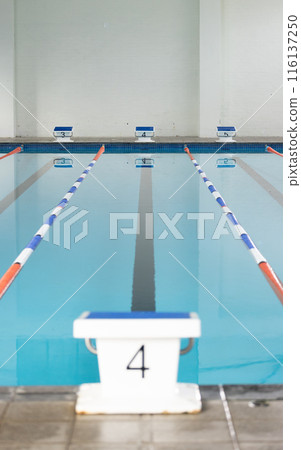Swimming lanes await competitors at an indoor pool, copy space 116137250
