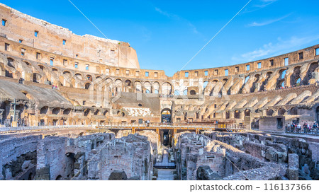 Interior of the Colosseum in Rome, Italy. The ancient amphitheater is a popular tourist destination, and this photograph captures its grandeur and historical significance. Interior of the Colosseum in Rome, Italy. The ancient amphitheater is a popular tourist destination, and this photograph captures its grandeur and historical significance. 116137366