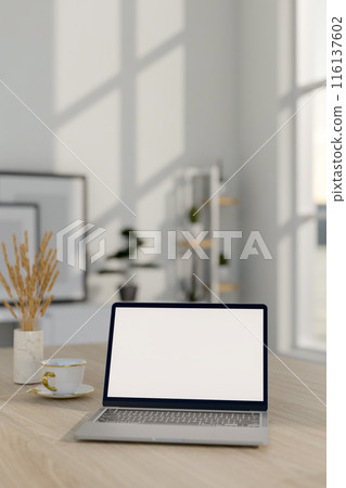 A close-up image of a laptop computer mockup on a wooden table in a minimalist white room. 116137602