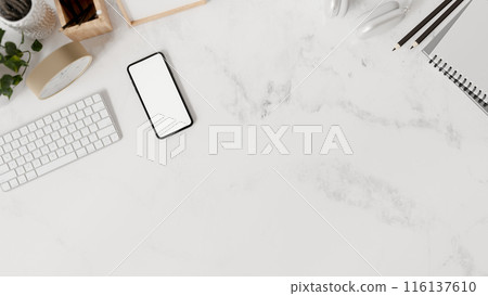 A white marble tabletop workspace features a keyboard, stationery, a smartphone, and a copy space. A white marble tabletop workspace features a keyboard, stationery, a smartphone, and a copy space. 116137610