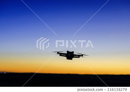 Drone flying in the sunset 116138279
