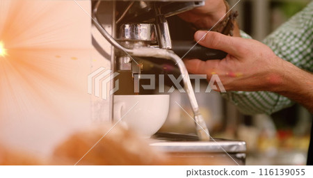 Image of glowing orange light over caucasian male barista making coffee Image of glowing orange light over caucasian male barista making coffee 116139055