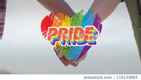 Image of rainbow heart and pride over hands of caucasian lesbian couple Image of rainbow heart and pride over hands of caucasian lesbian couple 116139065
