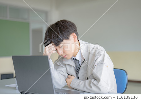 A man in work clothes suffering A man in work clothes suffering 116139136