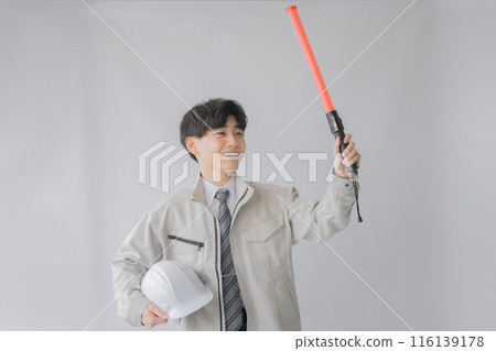 Young workwear man with guide and helmet Young workwear man with guide and helmet 116139178