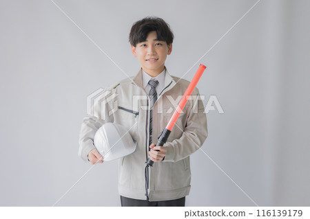 Young workwear man with guide and helmet 116139179