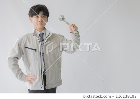 Man in work clothes with a spanner Man in work clothes with a spanner 116139192