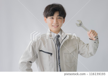 Man in work clothes with a spanner Man in work clothes with a spanner 116139193