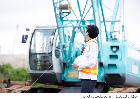Workers working at a construction site Workers working at a construction site 116139420