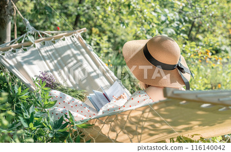 Young woman relaxing in a hammock 116140042