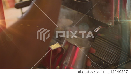 Image of hands of barista frothing milk using machine at a cafe Image of hands of barista frothing milk using machine at a cafe 116140257