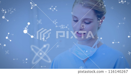 Image of molecules flowing over female doctor with face mask using digital tablet 116140267