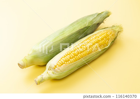 Fresh corn on a yellow background Fresh corn on a yellow background 116140370