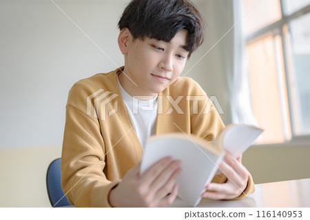 A young man reading a book A young man reading a book 116140953