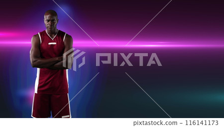 Image of african american male basketball player with arms crossed on purple background 116141173