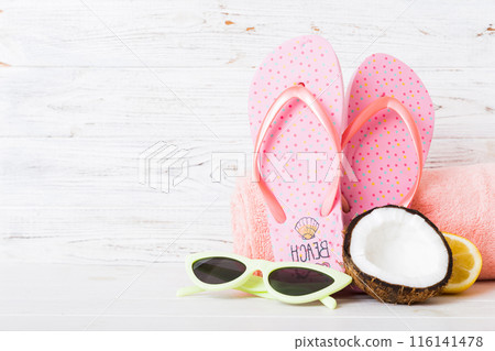 Top view composition of flip flops placed with beach accessories perspective view on table background. Tropical summer vacation concept Flat lay 116141478