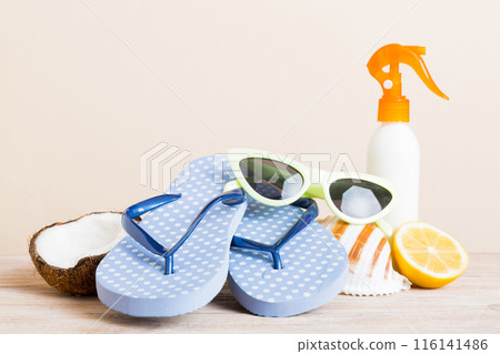 Top view composition of flip flops placed with beach accessories perspective view on table background. Tropical summer vacation concept Flat lay 116141486