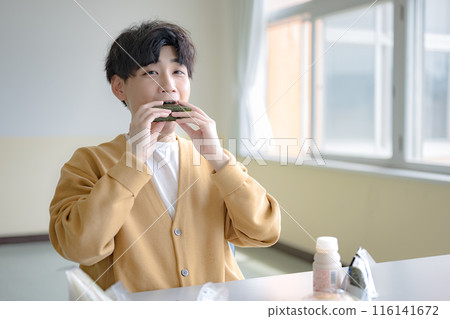 Young man with rice balls Young man with rice balls 116141672