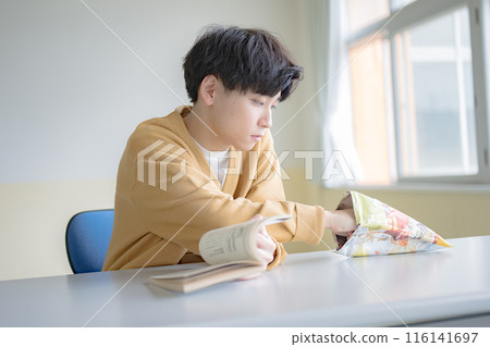 Boy eating potato chips Boy eating potato chips 116141697