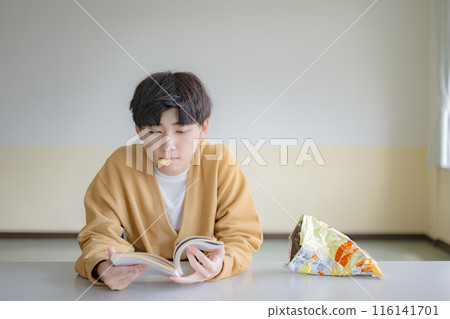 Boy eating potato chips Boy eating potato chips 116141701