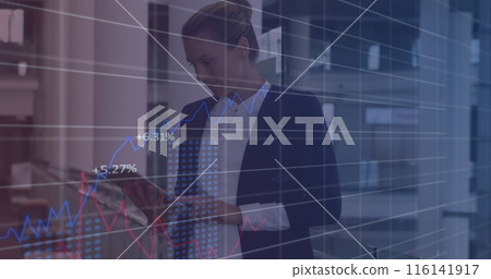 Caucasian chef wearing suit checking tablet with graphs Caucasian chef wearing suit checking tablet with graphs 116141917