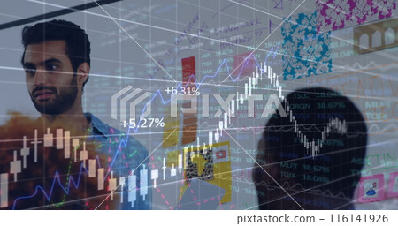 A bearded Middle Eastern man studies vivid stock data on a screen 116141926