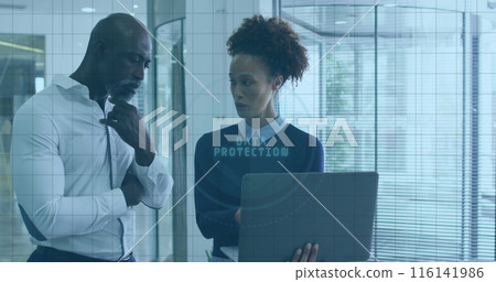 African American executive and biracial coworker holding laptop, discussing work 116141986