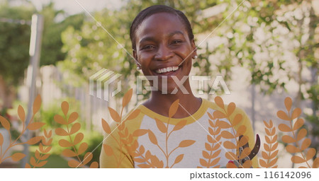 African American woman standing outdoors, wearing yellow shirt, smiling African American woman standing outdoors, wearing yellow shirt, smiling 116142096
