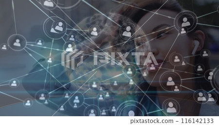 A young biracial woman with brown hair and light brown skin is looking at network A young biracial woman with brown hair and light brown skin is looking at network 116142133