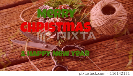 Scissors, pine cones, and twine rest on wooden surface 116142151