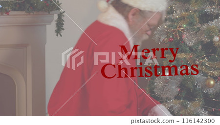 Caucasian senior male wearing Santa Claus costume decorating Christmas tree Caucasian senior male wearing Santa Claus costume decorating Christmas tree 116142300