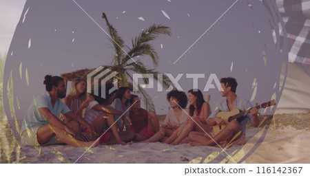Group of friends enjoying time on beach, one playing guitar Group of friends enjoying time on beach, one playing guitar 116142367