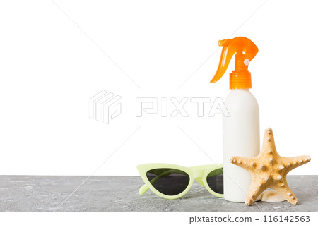 Professional Summer face skincare. Unbranded flacon with moisturizing liquid. Cream or lotion. Summer decorations, seashell and starfish, on table with isolated background. Beauty concept Perspective Professional Summer face skincare. Unbranded flacon with moisturizing liquid. Cream or lotion. Summer decorations, seashell and starfish, on table with isolated background. Beauty concept Perspective 116142563