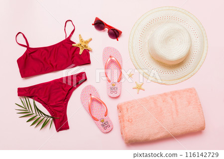 Woman swimwear and beach accessories flat lay top view. Top view with bikini outfit on color background. Vacation concept copy space Woman swimwear and beach accessories flat lay top view. Top view with bikini outfit on color background. Vacation concept copy space 116142729