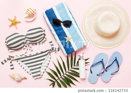 Woman swimwear and beach accessories flat lay top view. Top view with bikini outfit on color background. Vacation concept copy space 116142733
