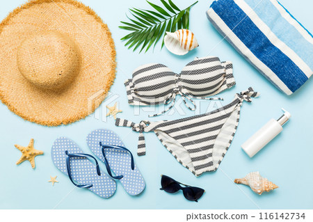 Woman swimwear and beach accessories flat lay top view. Top view with bikini outfit on color background. Vacation concept copy space 116142734