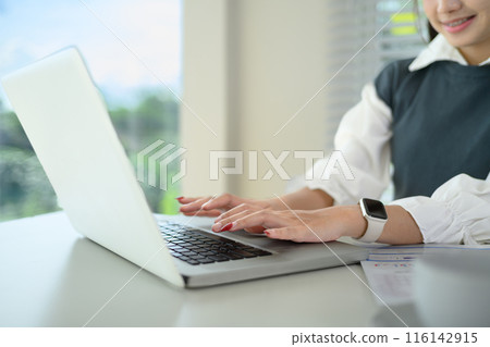 Close up businesswoman hands typing on laptop keyboard internet marketing and freelance work concept 116142915