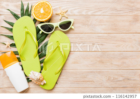Top view composition of flip flops placed with beach accessories top view on table background. Tropical summer vacation concept Flat lay 116142957