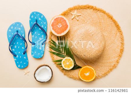 Top view of various seashells placed near colorful fruit and stylish summer accessories on table background. Summer concept. Flat lay. Top view with copy space for text Top view of various seashells placed near colorful fruit and stylish summer accessories on table background. Summer concept. Flat lay. Top view with copy space for text 116142981