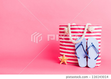 Stylish bag with beach accessories . Summer holiday concept. beach bag with straw hat with space for text 116143014
