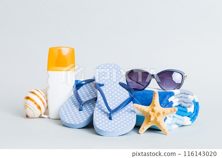 Top view composition of flip flops placed with beach accessories perspective view on table background. Tropical summer vacation concept Flat lay 116143020