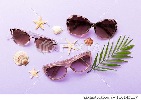 sunglasses with seashell lying on table background. Sunglasses on summer background. Top view flat lay with copy space for text sunglasses with seashell lying on table background. Sunglasses on summer background. Top view flat lay with copy space for text 116143117