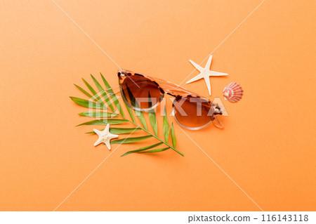 sunglasses with seashell lying on table background. Sunglasses on summer background. Top view flat lay with copy space for text sunglasses with seashell lying on table background. Sunglasses on summer background. Top view flat lay with copy space for text 116143118