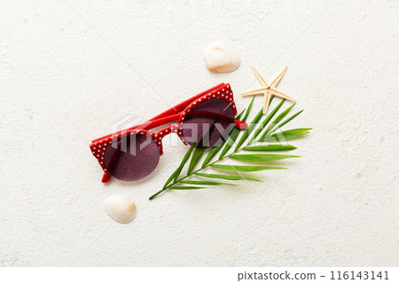 sunglasses with seashell lying on table background. Sunglasses on summer background. Top view flat lay with copy space for text sunglasses with seashell lying on table background. Sunglasses on summer background. Top view flat lay with copy space for text 116143141