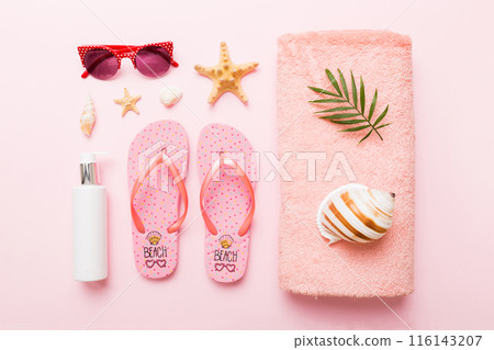 Summer holiday concept. Top view of beach towel, flip flop and sunscreen cream on table Top view with copy space for text Summer holiday concept. Top view of beach towel, flip flop and sunscreen cream on table Top view with copy space for text 116143207