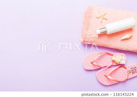 Summer holiday concept. Top view of beach towel, flip flop and sunscreen cream on table Top view with copy space for text 116143224